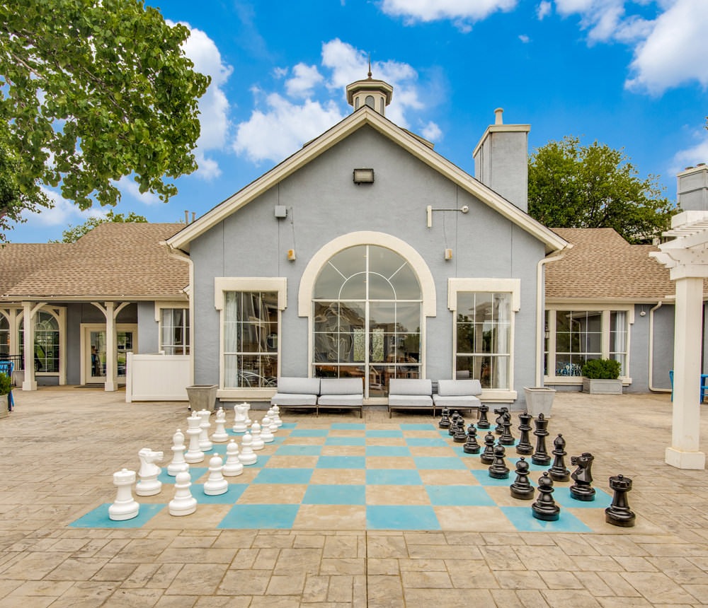 large chess board and standing pieces outside the clubhouse
