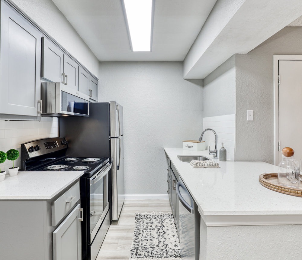 brightly lit c-ahaped kitchen with light, open countertop