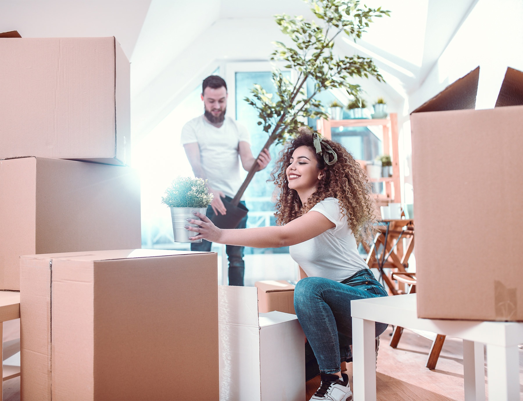 Young couple unpacking boxes in a new apartment home
